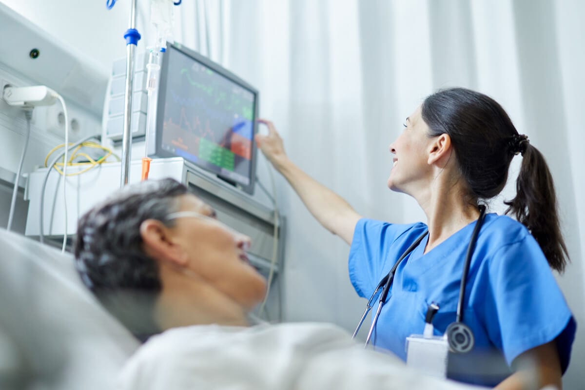 Nurse in hospital checking patient vitals